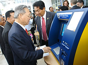 H.E. Sr. Minister Keat Chhon, Minister of Economy and Finance, using ACLEDA Bank's ATM